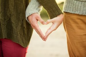 Couple making a heart shape with their hands