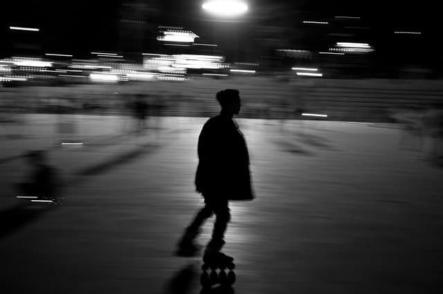 Black and white photo of inline skater with motion blur