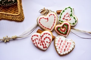 Flatlay photo of holiday heart cookies on white background
